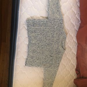 A white and blue threaded design knit sweater.